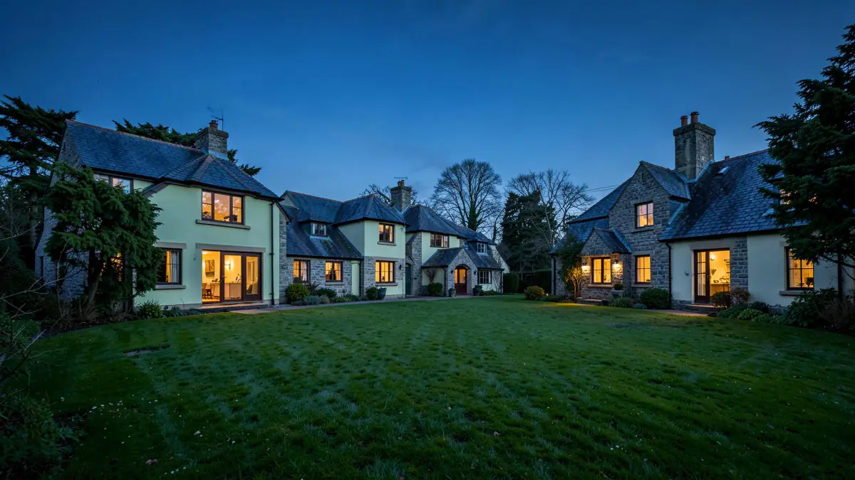 The Hollybush Court houses lit at dusk